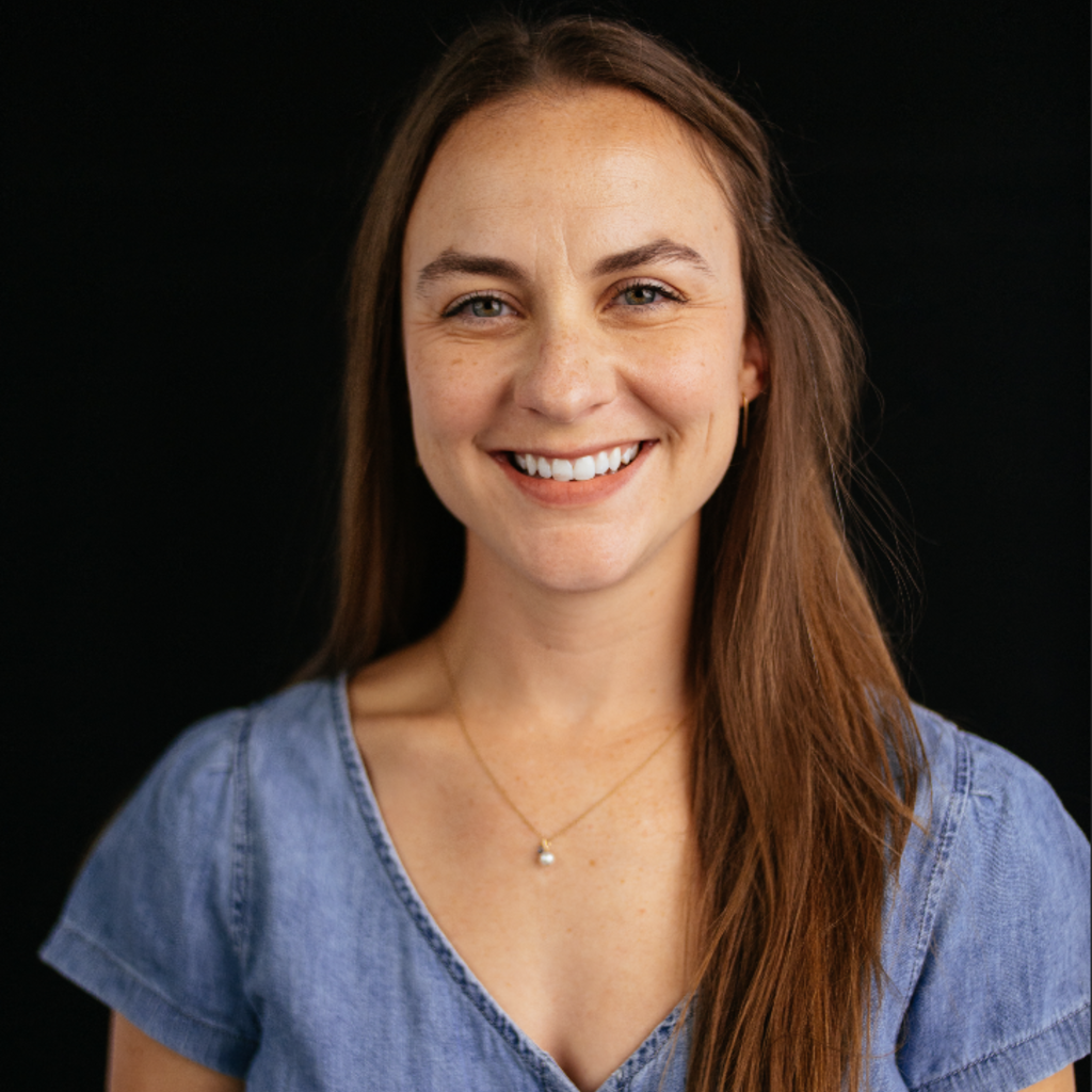 smiling woman in front of black background